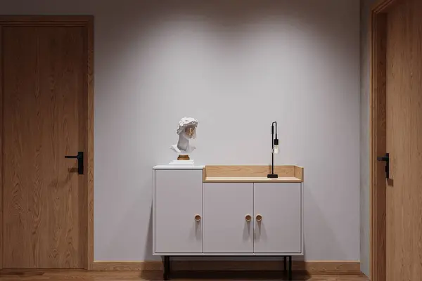 A white shoe cabinet standing by the foyer space in the studio apartment.