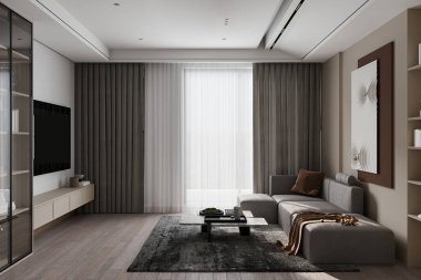 Güzel, gri bir kanepe çağdaş bir odada, duvarında beyaz ve kahverengi bir poster çerçevesi asılı duruyor..