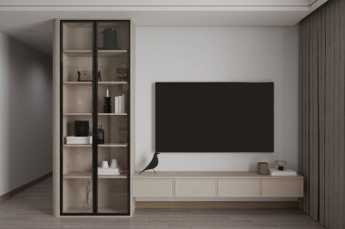 Oturma odasında minimalist bir iç mekan ve televizyonun yanında cam kapaklı bir dolap var..