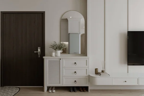 A white shoe cabinet with wall attached mirror in the foyer space.