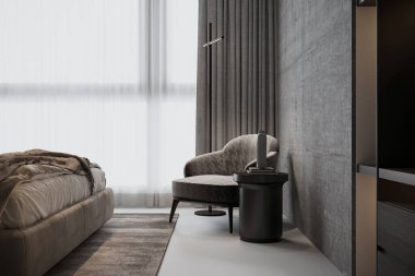 Yatak odasının iç kısmında bir koltuk ve bir konsol masası var..