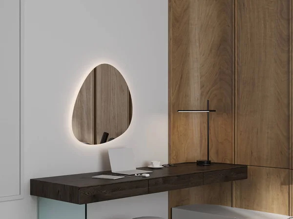 A bedroom with a minimalist console table and sculptural mirror
