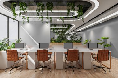 Bolca doğal ışığı, minimalist dekorasyonu ve çalışma istasyonu olan modern bir açık plan ofisi.