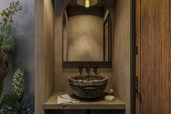 A cafe restroom interior with a stone sink and concrete wall