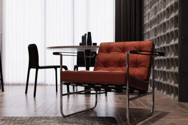 Oturma odasının içinde rahat kahverengi bir koltuk var..