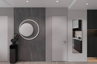 Modern ve zarif bir koridorun büyük yuvarlak bir aynası ve minimalist bir tarzı var..