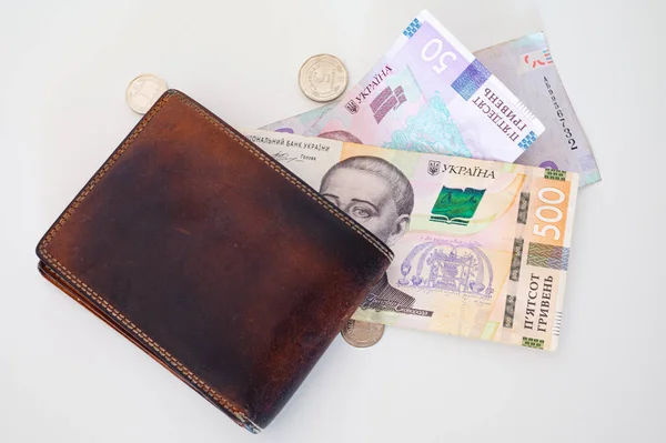 stock image Ukrainian money, coins, brown leather wallet on the white background. For financal, economy, housing, mortage, cost of living, Ukraine