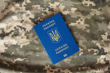 Ukrainian civil foreign passport on military camouflage pixel background. Border control clipart