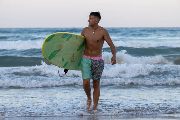 surfer on the beach with surfboard