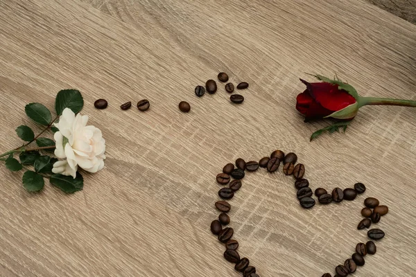 a cup of coffee with coffee and a heart of red coffee on a wooden table. top view. copy space.