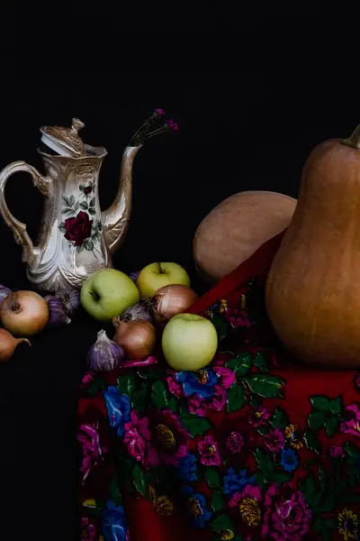 still life with fruits and flowers, on black background. autumn still life. autumn season concept