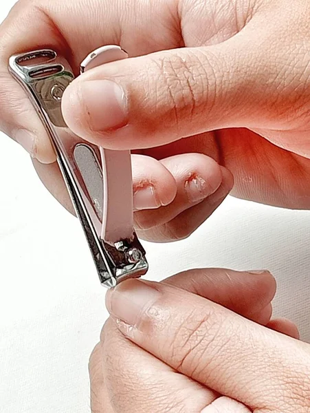 Cut nails with nail clippers.