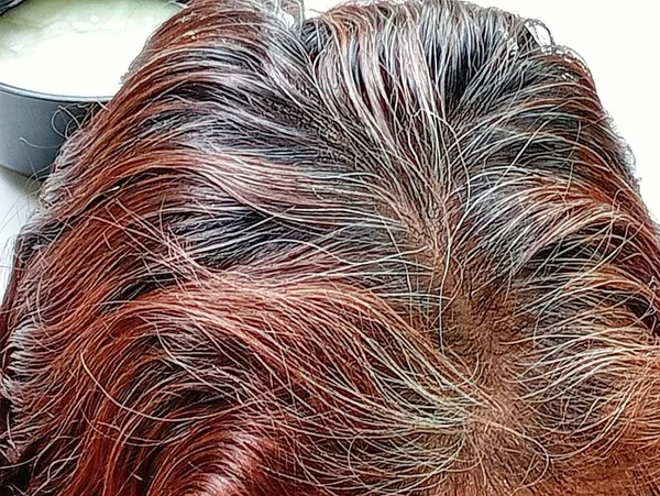 Grey hair of a 59 years old woman.