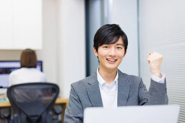 一个快乐的日本男人在办公室的笔记本电脑上工作的肖像 — 图库照片