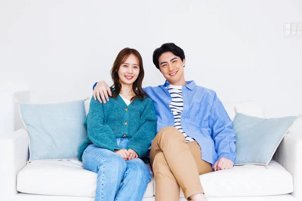 young couple on couch in living room