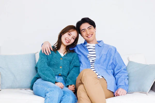 young couple on couch in living room