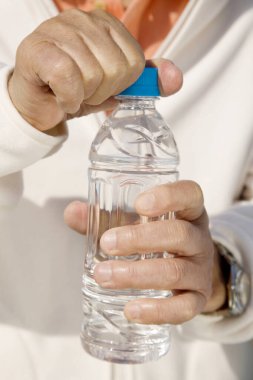 Bir şişe suyla insan eli.