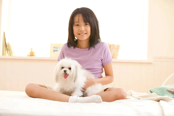 portrait of adorable happy Japanese girl with her puppy