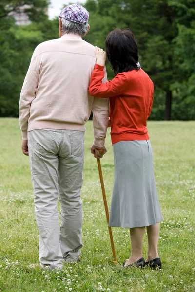 happy senior asian couple with walking stick outdoor