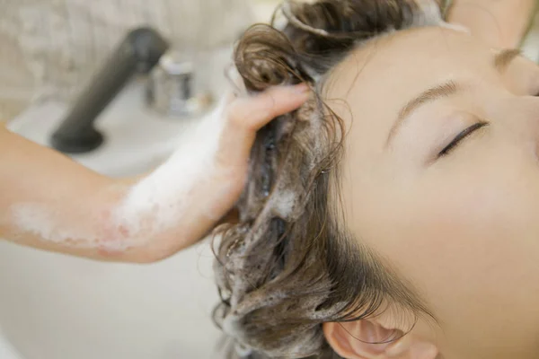 stock image woman getting hair treatment in salon. Female client having her hair washed in a beauty salon 