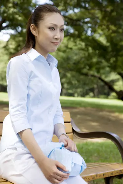 Gyönyörű Mosolygós Fiatal Ázsiai Padon Parkban — Stock Fotó