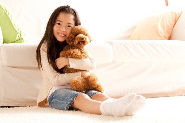 portrait of adorable happy Japanese girl with her puppy