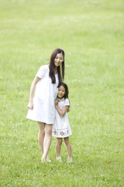 Japon ailesi yeşil yaz parkında dinleniyor. 