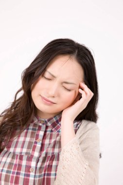 Beyaz arka planda baş ağrısından muzdarip güzel bir genç kadının portresi.