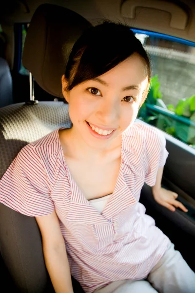 Arabada Oturan Kameraya Gülümseyen Güzel Bir Genç Kadının Portresi — Stok fotoğraf