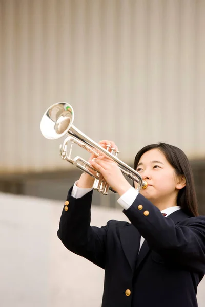 stock image portrait of beautiful japanese schoolgirl holding trumpet 