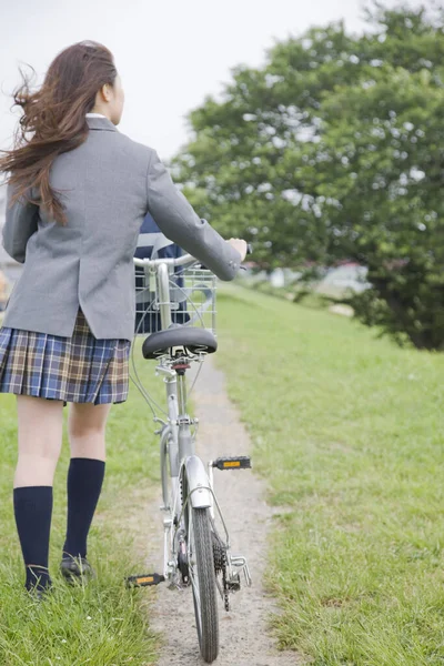 stock image portrait of young asian student with bicycle in summer park