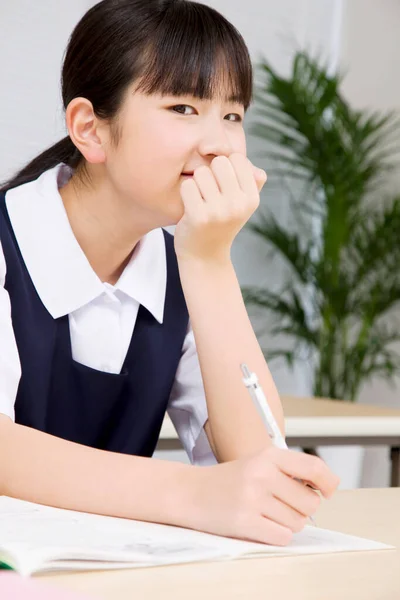 Young Japanese Schoolgirl Writing Notes While Studying School — Stock Photo, Image
