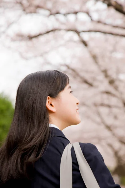 나무의 배경에 유니폼에 소녀의 초상화 — 스톡 사진