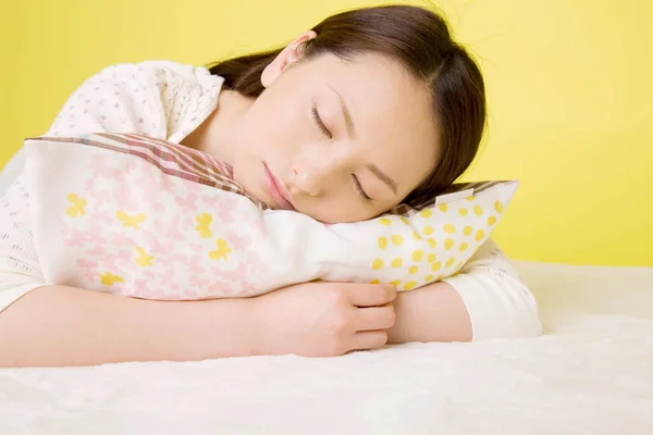 Портрет Красивой Японской Женщины Лежащей Подушке Спящей Желтом Фоне — стоковое фото