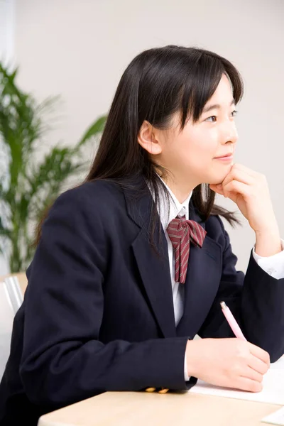 Young Japanese Schoolgirl Writing Notes While Studying School — Stock Photo, Image