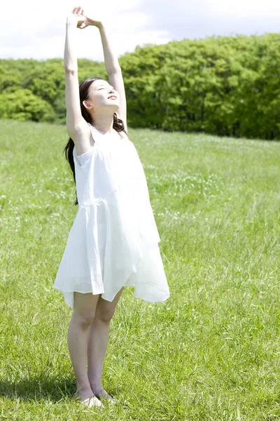 Beautiful Young Japanese Woman White Dress Stretching Arms While Standing — Stock Photo, Image