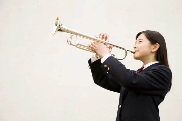 stock image portrait of beautiful japanese schoolgirl holding trumpet 