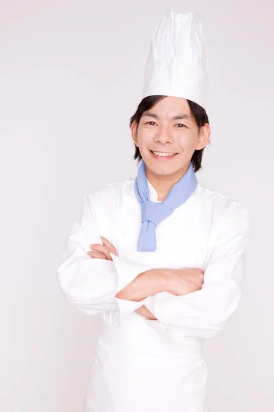 portrait of a young asian chef with crossed arms