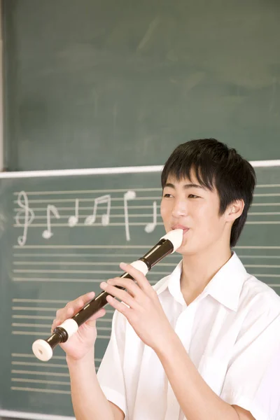 Young Asian Man Playing Flute Classroom — Stock Photo, Image