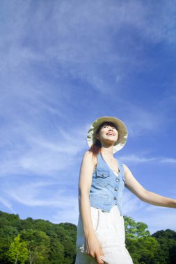 Parkta yürüyen şapkalı kadın. 