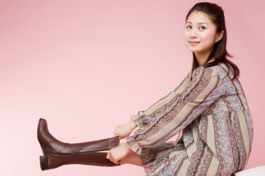 Çizme giyen genç Asyalı kadın. 