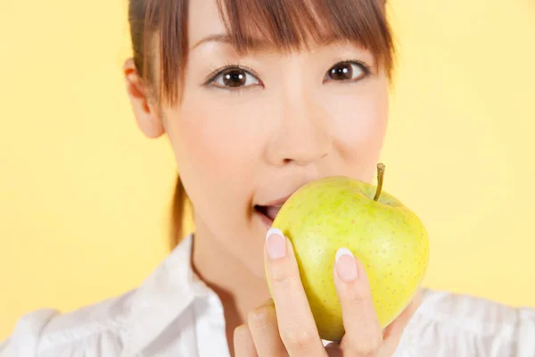 Asian Young Woman Eating Apple Isolated Yellow Background — Stock Photo, Image