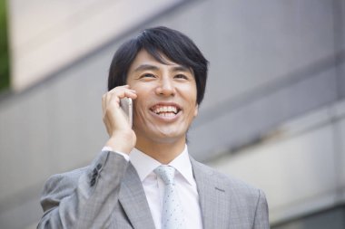 Akıllı telefon kullanarak Asyalı işadamını kapatın.