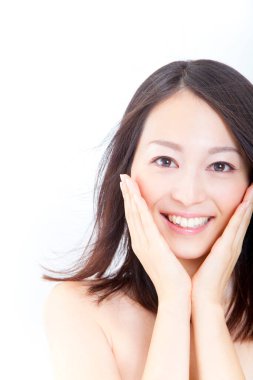 Stylish brunette woman touching face, closeup of japanese lady on white