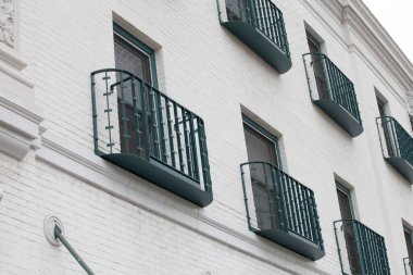 Yeşil balkonlu tuğla beyaz duvar manzarası 