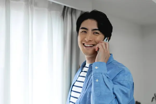 happy young asian man with phone