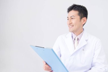 Elinde dosya tutan laboratuvar önlüklü bir adam.