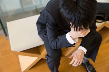 Baş ağrısı çeken Asyalı iş adamı 