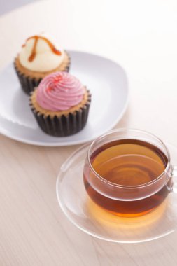 cup of tea and cakes on white table