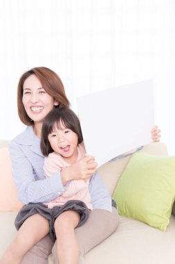 Anne ve kızı gülümsüyor.